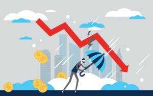 Man holding an umbrella and weathering a storm with financial chart in the background showing a downward trend