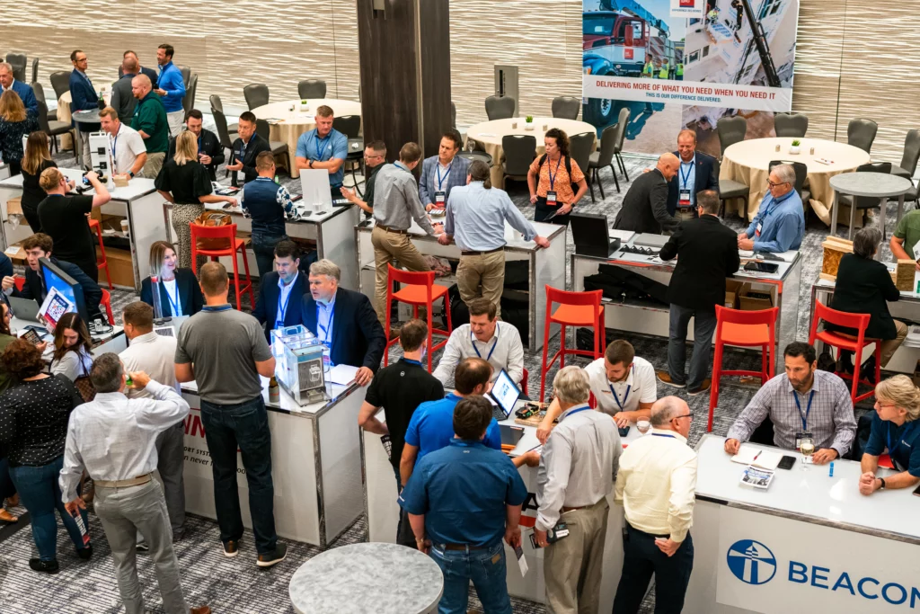 Crowd of people talking at various vendor booths