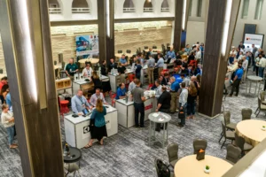 Crowd of people talking at various vendor booths