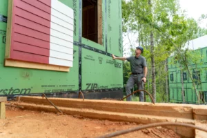Steven Sanders-Myers, purchasing manager at Brightwater Homes stands outside of an unfinished home