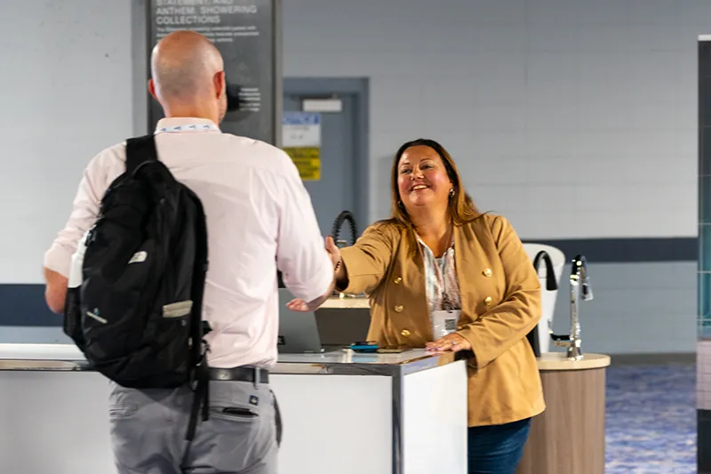 Man speaking to woman behind counter
