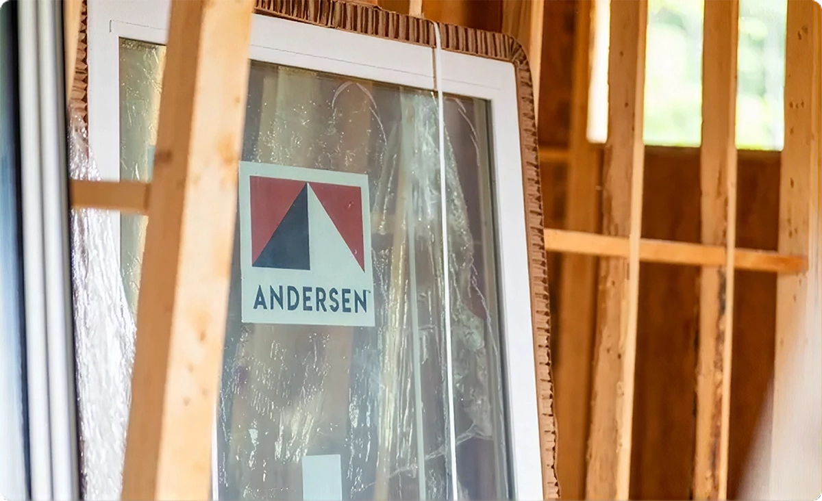 Andersen window ready for installation inside a framed home under construction.